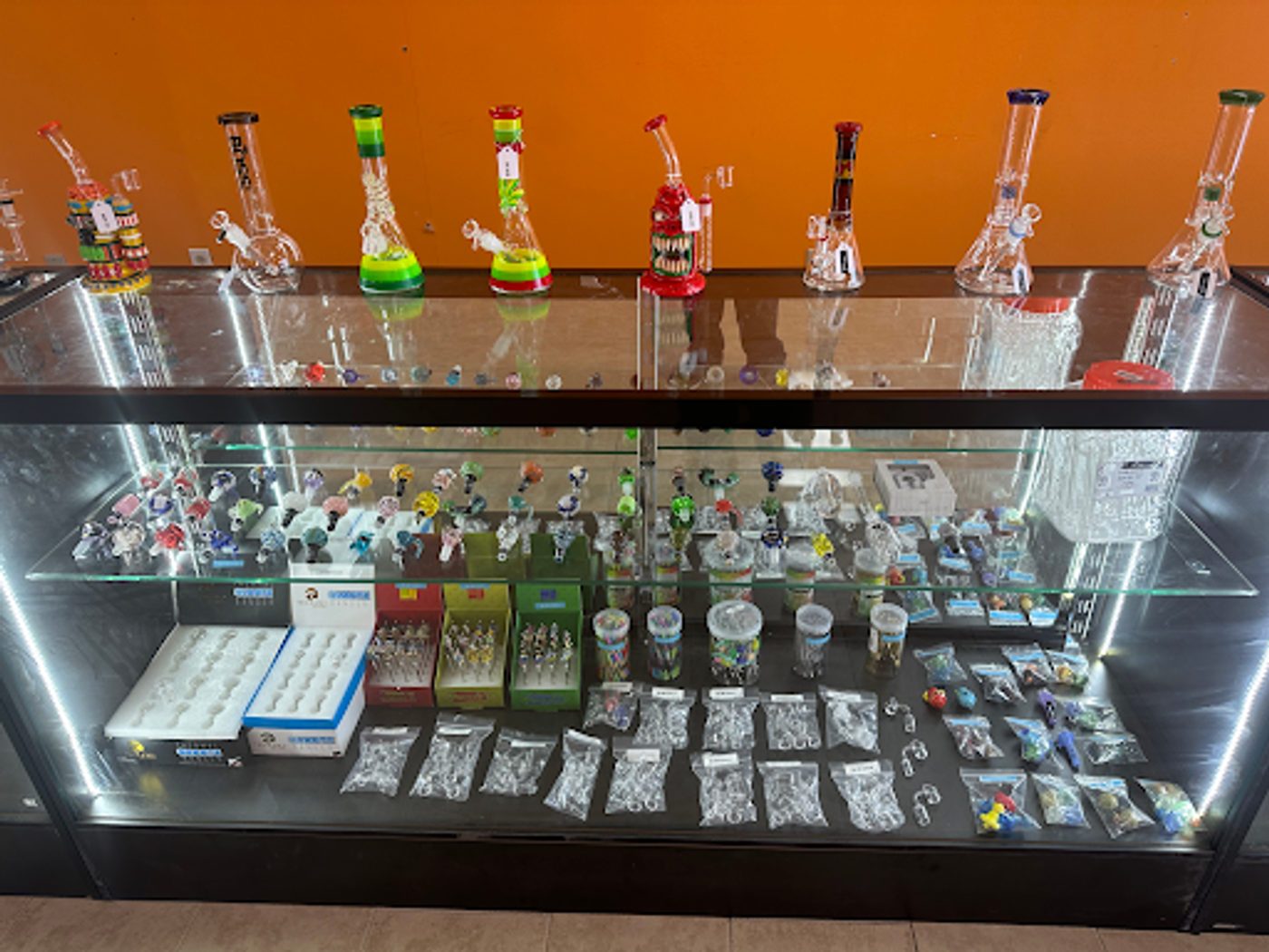 Lit display case with glassware